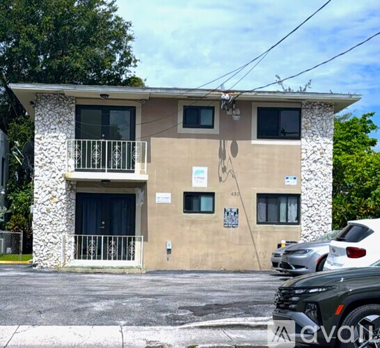 A two-story building with a balcony on the second floor.