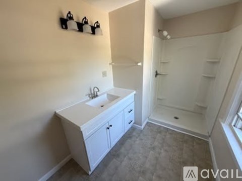 A kitchen with a white refrigerator and wooden cabinets.