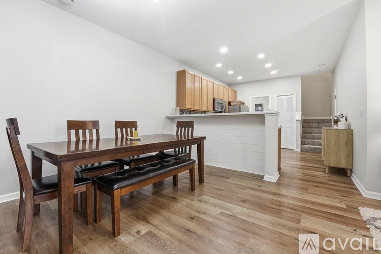 A kitchen with a table and chairs in the foreground.