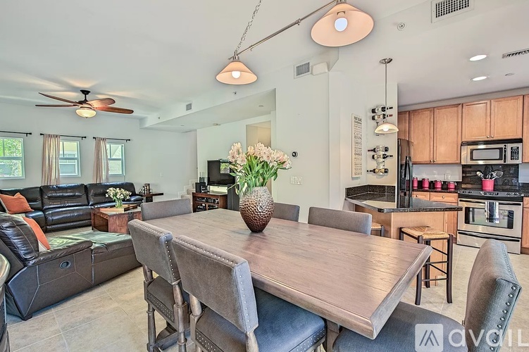 A modern kitchen and dining area with a wooden table and chairs.