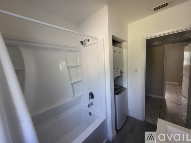 A bathroom with a white tub and a white sink.
