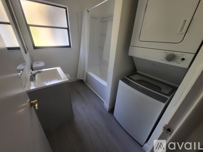 A small bathroom with a washer and dryer.