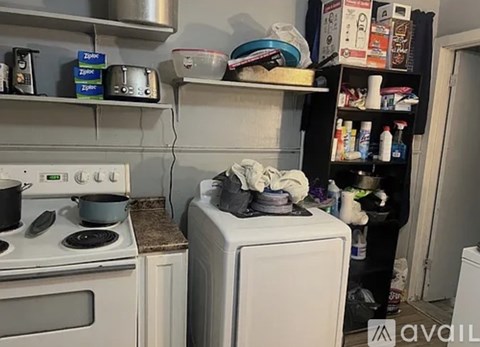 A kitchen with a stove, oven, and a washing machine.