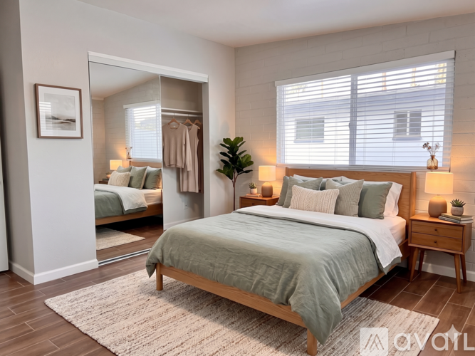 A bedroom with a large bed and a mirrored closet.