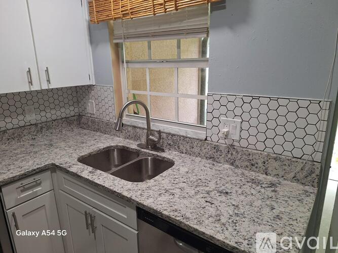 A kitchen with a sink and a window.