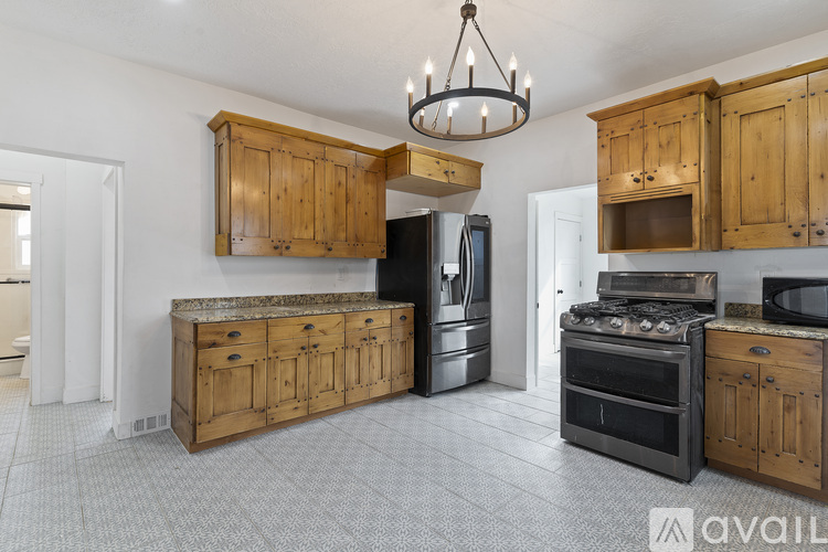 A kitchen with wooden cabinets and a black stove top oven.