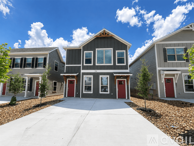 A row of houses with a clear blue sky above them.