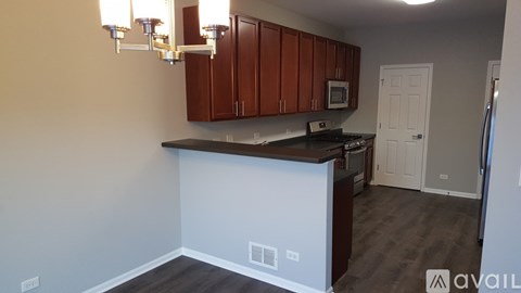 A kitchen with brown cabinets and a white island.