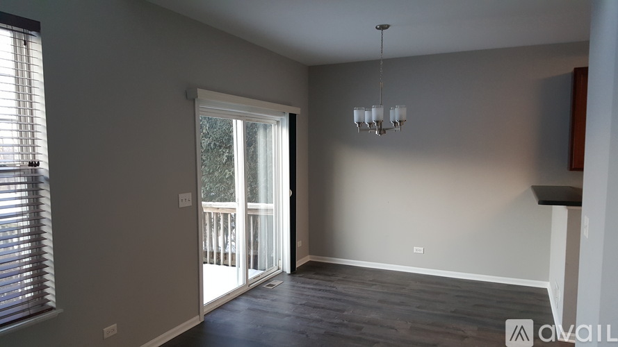 A room with a sliding glass door leading to a balcony.