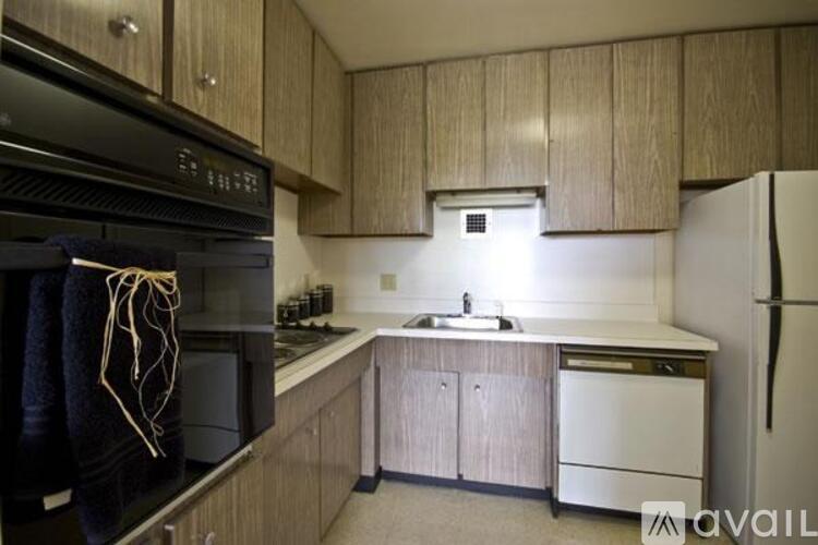 A kitchen with wooden cabinets and a white countertop.