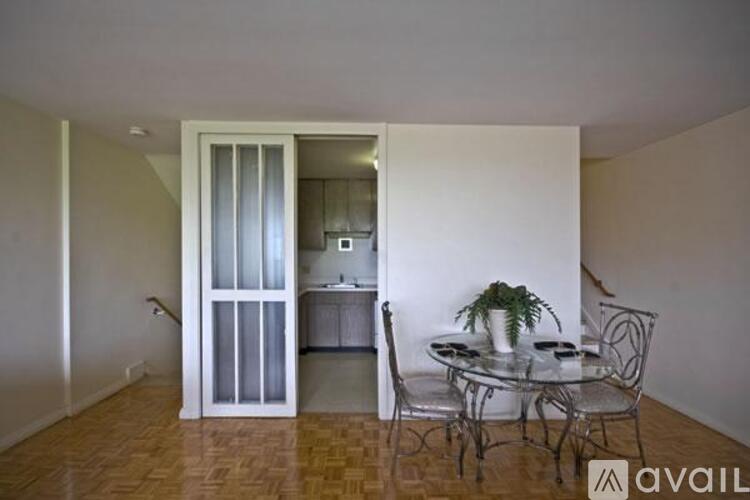 A dining room with a glass table and chairs.