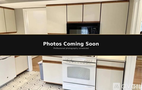 A kitchen with white cabinets and a white oven.