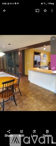 A room with a wooden table and chairs.