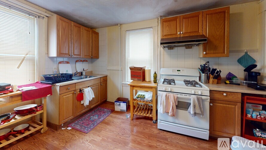 A kitchen with wooden cabinets and a white oven.