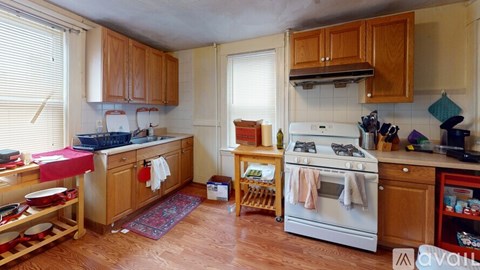 A kitchen with wooden cabinets and a white oven.