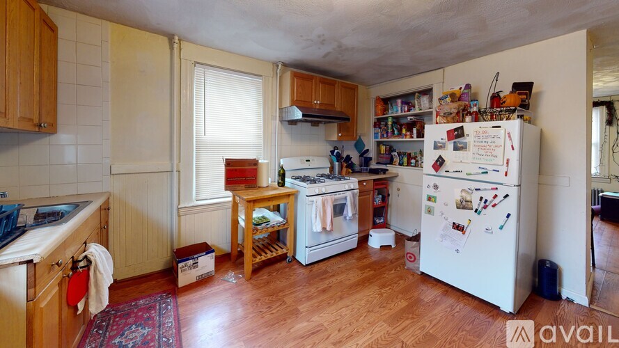 A kitchen with wooden cabinets and a white fridge.