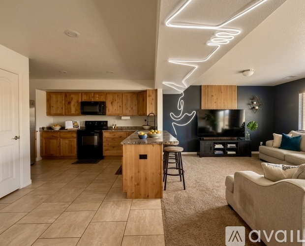 A modern kitchen with wooden cabinets and a black stove top oven.