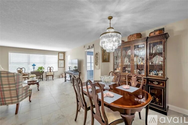 A dining room with a wooden table and chairs.