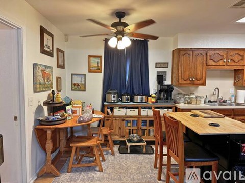 A kitchen with a table and chairs in the middle of the room.