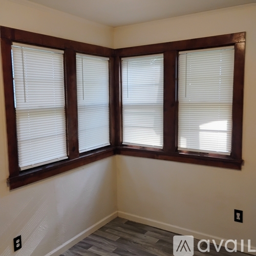 A room with a window and a wooden frame.