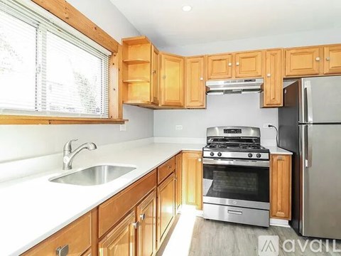 A kitchen with wooden cabinets and stainless steel appliances.