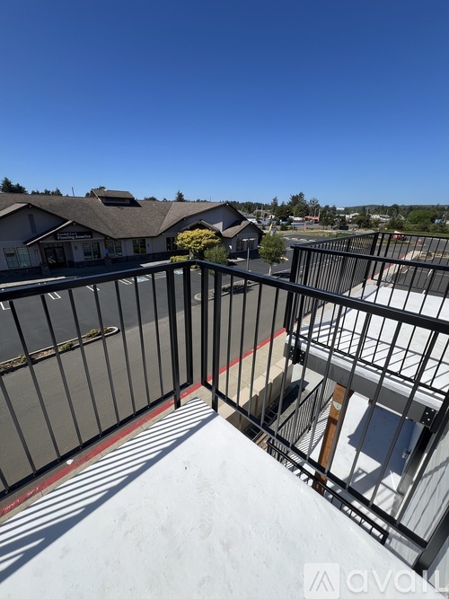 A balcony with a black railing and a red line on the floor.
