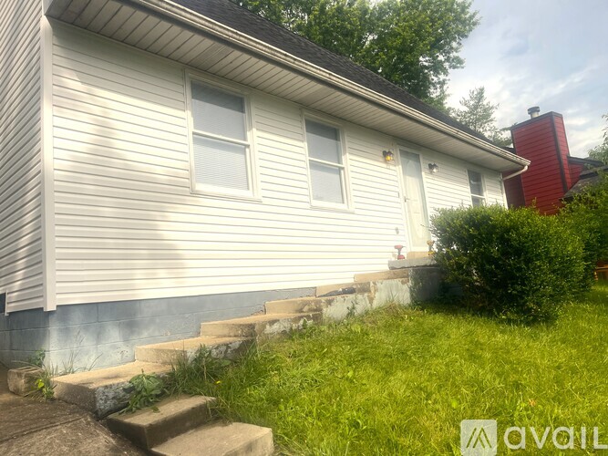 A house with a red chimney is for sale.