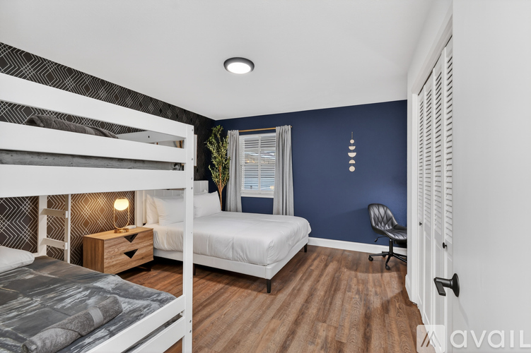 A bedroom with a bunk bed and a single bed.
