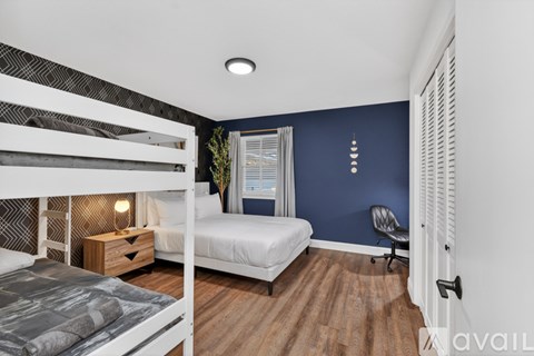 A bedroom with a bunk bed and a single bed.