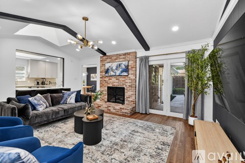 A living room with a fireplace and a painting on the wall.