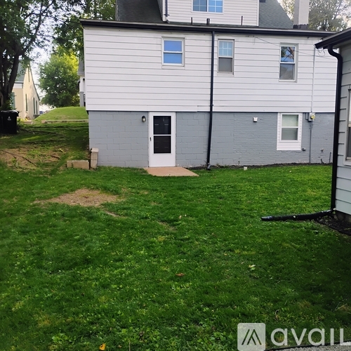 A house with a grey and white exterior and a black door.
