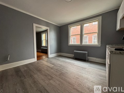 A room with grey walls and a wooden floor.