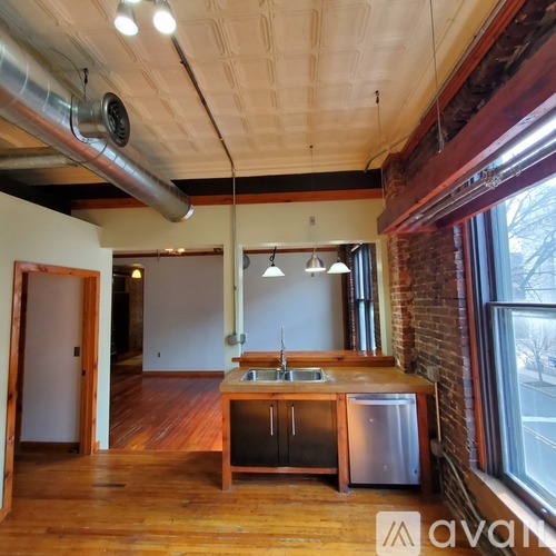 A kitchen with a wooden counter and a sink.