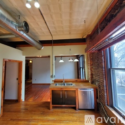 A kitchen with a wooden counter and a sink.