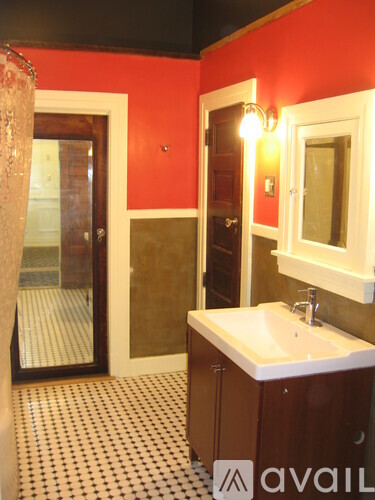 A bathroom with a sink and mirror.