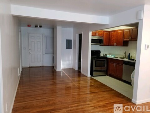 A kitchen with wooden floors and white walls.
