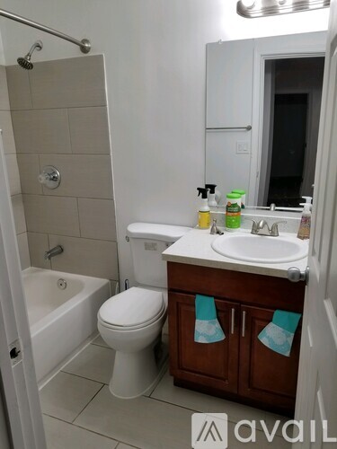 A bathroom with a white toilet, sink, and bathtub.
