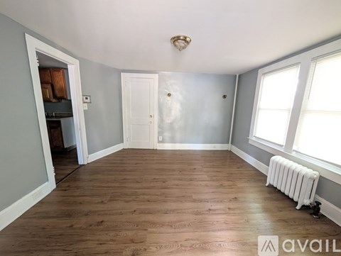 A room with wooden floors and a white ceiling with a light fixture.