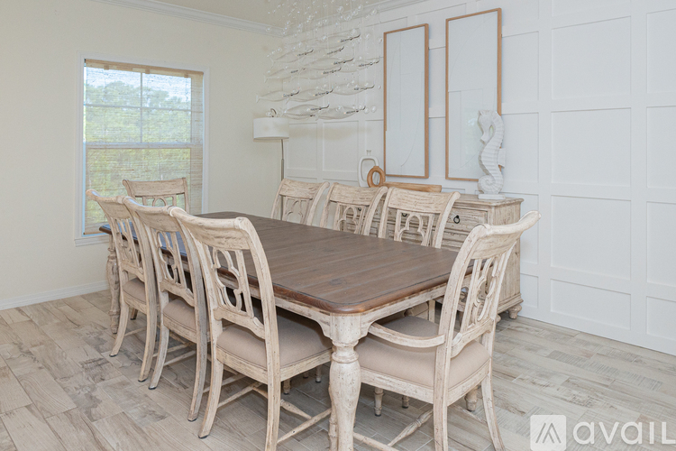 A dining room with a wooden table and chairs.