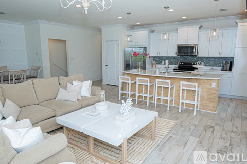 A living room with a beige couch and a white coffee table.