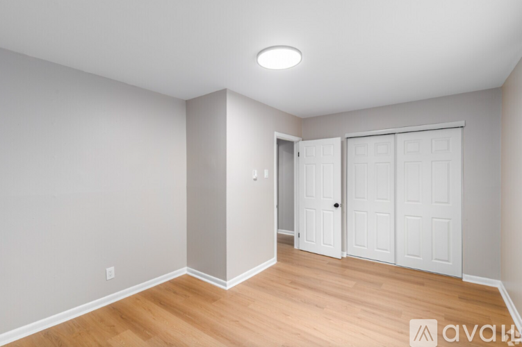 A room with a white door and a white wall.