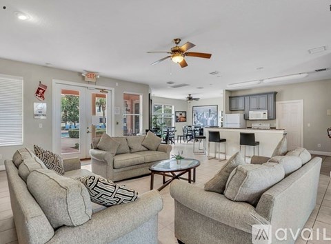 A living room with a beige couch and a coffee table.