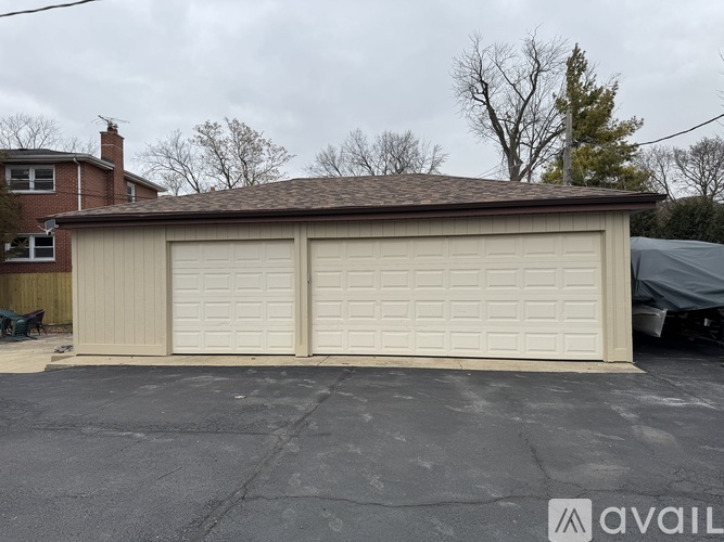 A two-car garage with a tan exterior is available for rent.