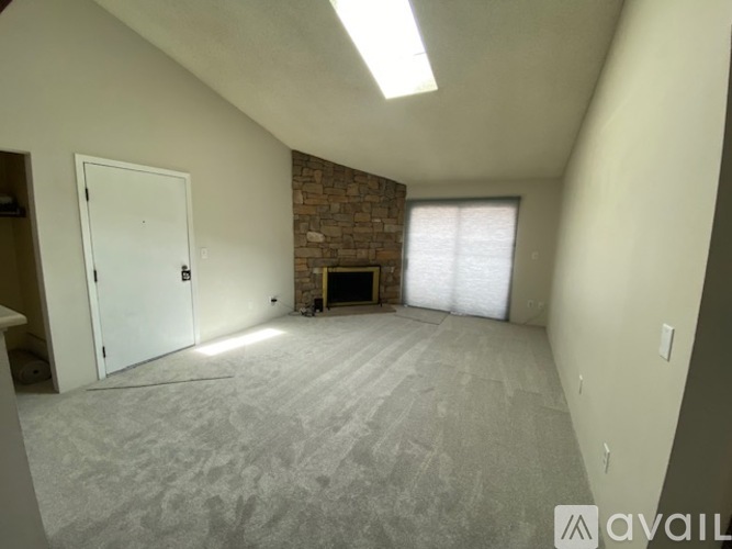 A room with a brick fireplace and a door.