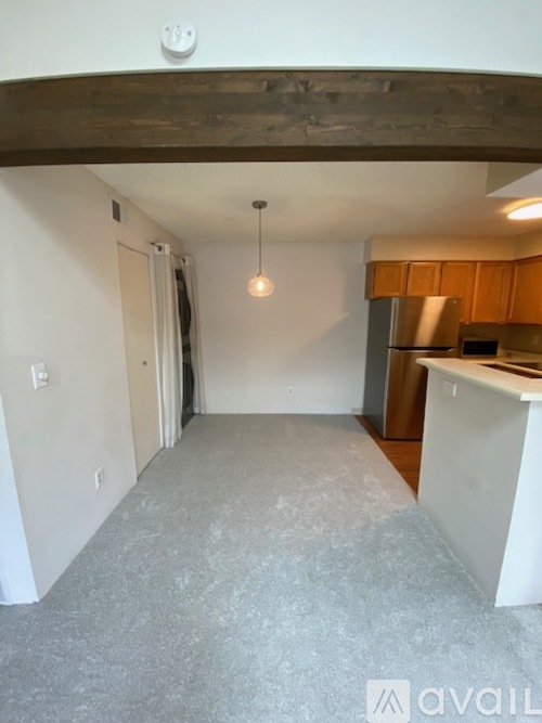 A kitchen with a refrigerator, microwave, and oven.