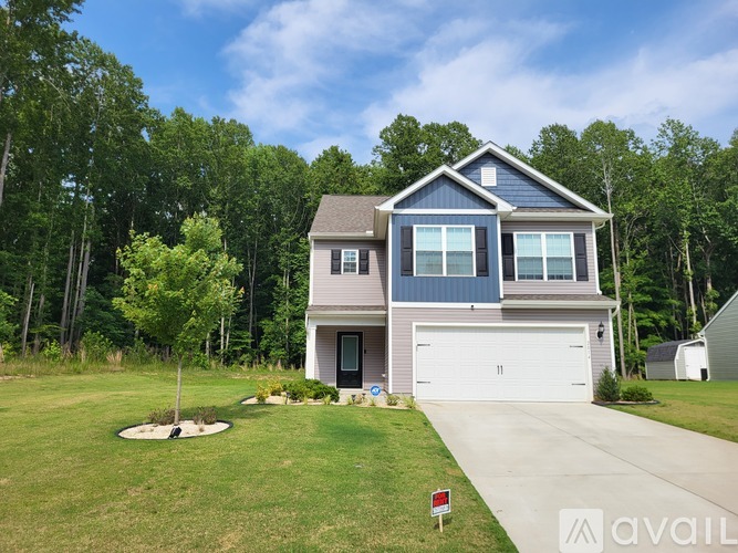 A house with a garage is for sale.