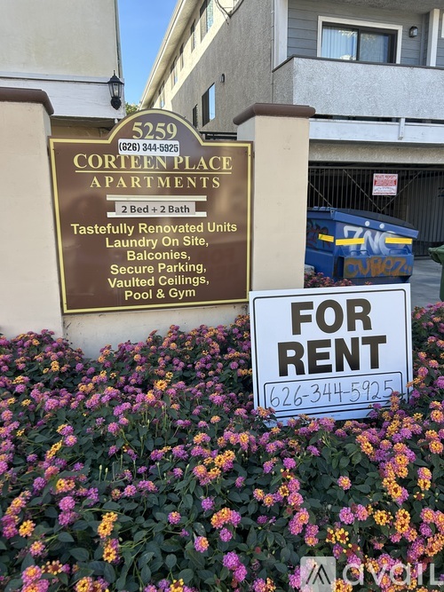 A sign for Corteen Place Apartments is displayed in front of a building.