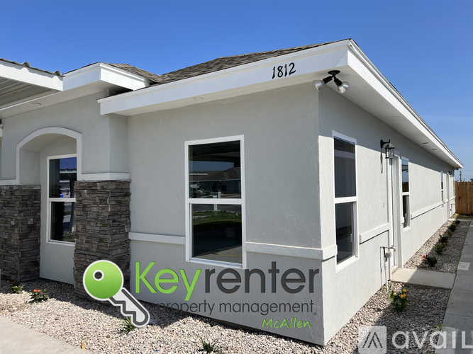 A house with the number 1812 on the roof and a Key Renter logo in the front yard.