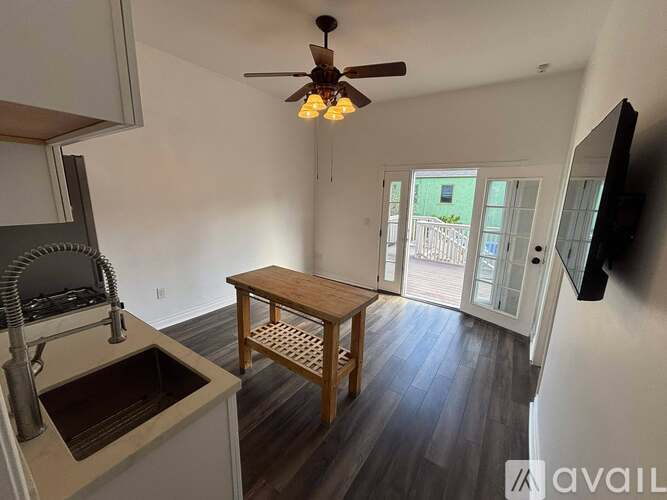 A kitchen with a sink and a table.