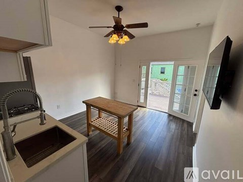 A kitchen with a sink and a table.